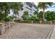 Attractive building exterior with brick paver driveway and lush landscaping at 1200 E Peppertree Ln # 607, Sarasota, FL 34242