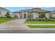 Two-story home with a paver driveway and lush landscaping at 15008 Derna Ter, Bradenton, FL 34211