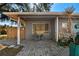 Relaxing covered front porch with a tiled walkway and comfortable seating at 2003 Princeton Ave, Bradenton, FL 34207