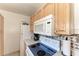 Close-up of kitchen appliances, including a Whirlpool microwave and electric range at 2003 Princeton Ave, Bradenton, FL 34207