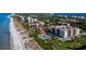 Aerial view of beachfront community with pool, beach, and condos at 2045 Gulf Of Mexico Dr # M1-502, Longboat Key, FL 34228