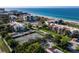 Aerial view of beachfront condominiums, tennis courts, and parking at 2045 Gulf Of Mexico Dr # M1-502, Longboat Key, FL 34228
