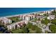 Aerial view of beachfront condominiums and lush landscaping at 2045 Gulf Of Mexico Dr # M1-502, Longboat Key, FL 34228