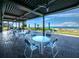 Beachfront patio with seating, umbrellas, and ocean views at 2045 Gulf Of Mexico Dr # M1-502, Longboat Key, FL 34228