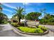 Gated community entrance with lush landscaping and signage for 