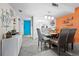 Dining area with a glass-top table, gray chairs, and nautical-themed decor at 2045 Gulf Of Mexico Dr # M1-502, Longboat Key, FL 34228
