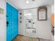 Bright blue door opens to a view of the kitchen and dining area at 2045 Gulf Of Mexico Dr # M1-502, Longboat Key, FL 34228