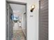 Entryway with tiled floor, gray door, and coastal decor, leading to the living area at 2045 Gulf Of Mexico Dr # M1-502, Longboat Key, FL 34228
