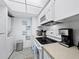 Kitchen featuring white appliances and in-unit laundry at 2045 Gulf Of Mexico Dr # M1-502, Longboat Key, FL 34228