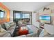 Coastal-themed living room with comfortable seating and a view of the balcony at 2045 Gulf Of Mexico Dr # M1-502, Longboat Key, FL 34228