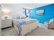 King-size bed in a main bedroom with ocean-inspired wall art at 2045 Gulf Of Mexico Dr # M1-502, Longboat Key, FL 34228