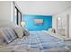 Main bedroom featuring a king-size bed and blue accent wall at 2045 Gulf Of Mexico Dr # M1-502, Longboat Key, FL 34228