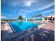 Community pool with blue water, lounge chairs, and access steps at 2045 Gulf Of Mexico Dr # M1-502, Longboat Key, FL 34228