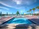 Close up view of the community spa with blue water and surrounding patio at 2045 Gulf Of Mexico Dr # M1-502, Longboat Key, FL 34228