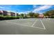 Tennis court with benches and lush landscaping at 2045 Gulf Of Mexico Dr # M1-502, Longboat Key, FL 34228