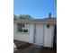 Simple back door entrance to the home with a single window at 222 27Th W St, Bradenton, FL 34205
