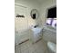 Bathroom with white vanity and round mirror at 222 27Th W St, Bradenton, FL 34205