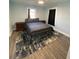 Bright bedroom with a double bed, nightstands, and wood-look flooring at 222 27Th W St, Bradenton, FL 34205