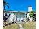 Front view of a white house with a black door and walkway at 222 27Th W St, Bradenton, FL 34205