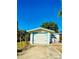 Detached garage with a white door and a small patio area at 222 27Th W St, Bradenton, FL 34205