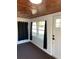 Sunroom features wood ceiling, windows, and dark curtains at 222 27Th W St, Bradenton, FL 34205