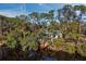 Bird's-eye view of a waterfront property surrounded by trees and water at 2340 Arden Dr, Sarasota, FL 34232