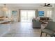 Open living space featuring a comfortable seating area and access to a balcony at 2905 Gulf Dr, Holmes Beach, FL 34217