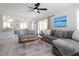 Bright living room with gray sectional sofa, wood coffee table, and access to balcony at 2905 Gulf Dr, Holmes Beach, FL 34217