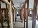 Hallway under renovation with exposed framing and plumbing at 3181 Irving St, Sarasota, FL 34237
