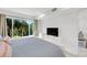 Bedroom with king bed, TV, and view of lush landscaping at 3320 Gulf Of Mexico Drive # 208C, Longboat Key, FL 34228