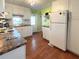 Clean kitchen with white cabinets, granite countertops, and modern appliances at 3416 Spanish Oak Ter, Sarasota, FL 34237