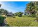 Expansive backyard with lush grass, tropical landscaping, and ample space at 348 Red Ash Cir, Englewood, FL 34223