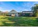 Spacious backyard with a screened-in pool area and lush lawn at 348 Red Ash Cir, Englewood, FL 34223