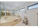 Spacious bathroom with soaking tub, large mirror, and tiled floor at 348 Red Ash Cir, Englewood, FL 34223