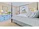 Bedroom with a four-poster bed, light-colored linens, and a blue dresser opposite the bed at 348 Red Ash Cir, Englewood, FL 34223