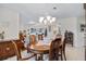 Dining room with wooden table, chairs, and hexagonal tiled floors, offering views into adjacent rooms at 348 Red Ash Cir, Englewood, FL 34223
