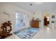 Bright foyer featuring white tile flooring, a decorative rug, and double doors with glass inserts at 348 Red Ash Cir, Englewood, FL 34223