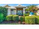 Welcoming front entrance with double doors, surrounded by neatly trimmed shrubs and greenery at 348 Red Ash Cir, Englewood, FL 34223