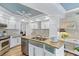 Modern kitchen with a large island, stainless steel appliances, and white cabinetry at 348 Red Ash Cir, Englewood, FL 34223