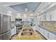 Modern kitchen with stainless steel appliances, double sink, and ample counter space at 348 Red Ash Cir, Englewood, FL 34223