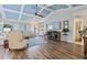 Inviting living room with coffered ceiling, wood-look flooring, and ample natural light at 348 Red Ash Cir, Englewood, FL 34223