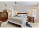 Main bedroom with wooden furniture, ceiling fan, and ensuite bathroom access at 348 Red Ash Cir, Englewood, FL 34223