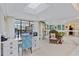 Home office with white built-in shelving, desk, and sliding glass doors to the pool at 348 Red Ash Cir, Englewood, FL 34223