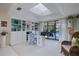 Bright home office with skylights, built-in shelving, and view of the pool at 348 Red Ash Cir, Englewood, FL 34223