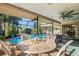 Covered patio with ornate outdoor dining furniture, perfect for relaxation by the pool at 348 Red Ash Cir, Englewood, FL 34223
