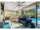 Screened-in pool area with a dining table, cushioned seating, and views of the pool at 348 Red Ash Cir, Englewood, FL 34223