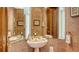 Half bathroom with tile flooring, pedestal sink, and large mirror at 350 Gulf Of Mexico Dr # 211, Longboat Key, FL 34228