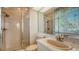 Tiled bathroom with shower stall, single vanity, and soft pink fixtures at 350 Gulf Of Mexico Dr # 211, Longboat Key, FL 34228