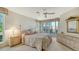 Bedroom with a king-size bed, ceiling fan, and access to a private balcony at 350 Gulf Of Mexico Dr # 211, Longboat Key, FL 34228