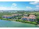 Stunning aerial view of a waterfront community with lush landscaping and a pool at 350 Gulf Of Mexico Dr # 211, Longboat Key, FL 34228
